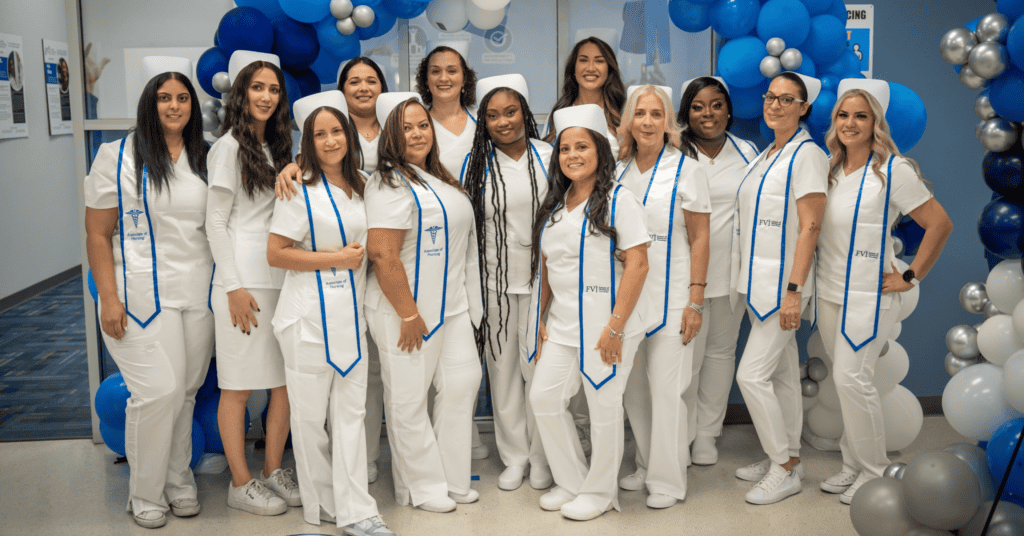 A group of Miramar ASN nursing degree program students posing in front of a balloon arch at the Miramar campus after a pinning ceremony