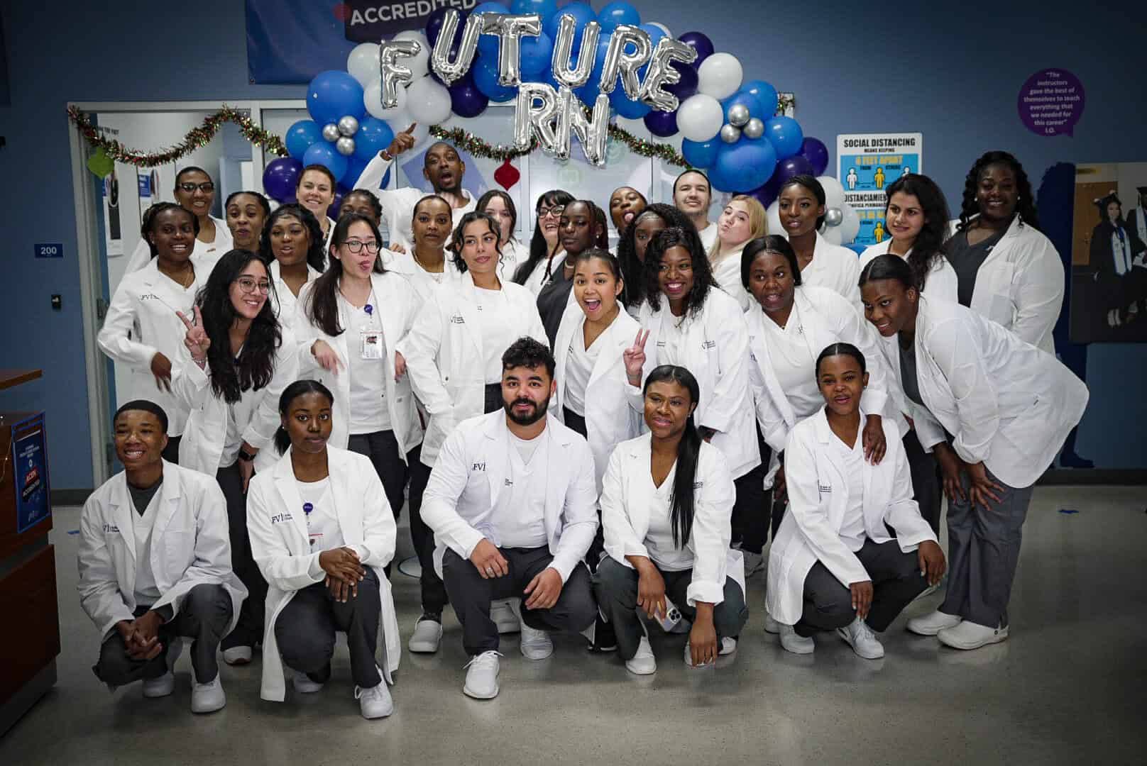 A group of South Florida ASN nursing students posing in front of a balloon arch after their nursing orientation - future RNs